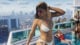 A girl in a bikini on a rooftop.